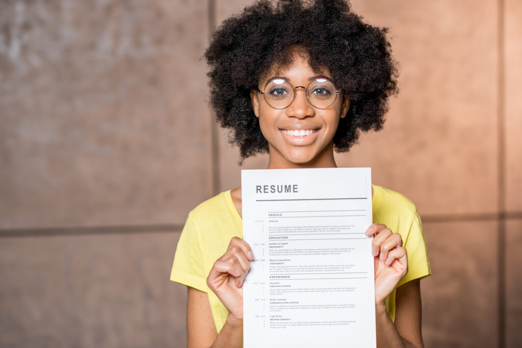 woman holding her resume to get hired