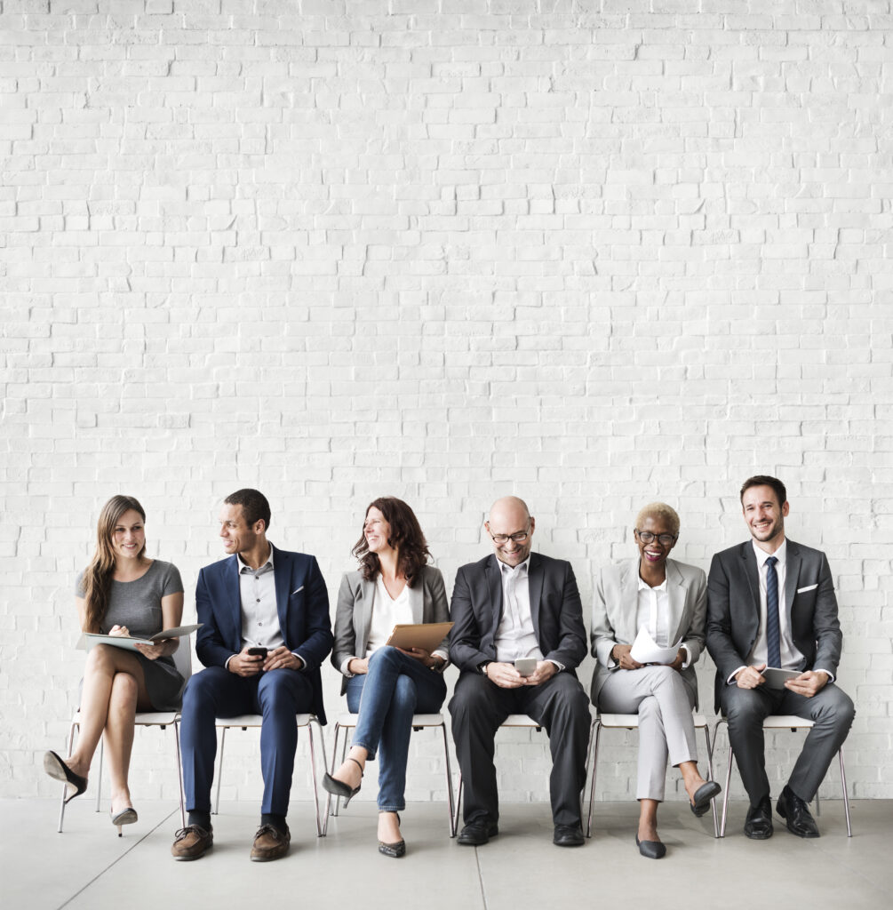 Job candidates sitting in chairs waiting for interviews